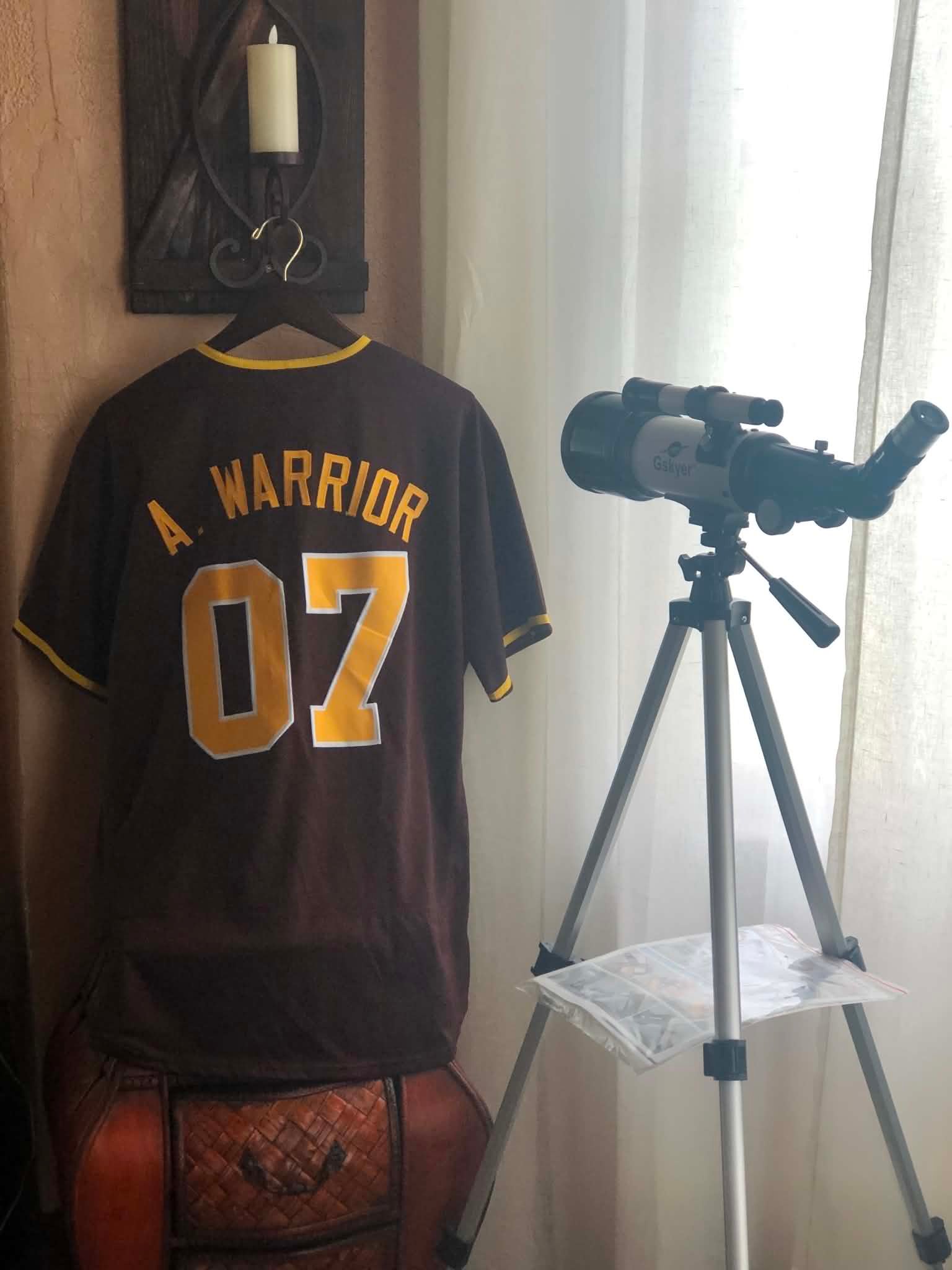 A. Warrior jersey beside telescope